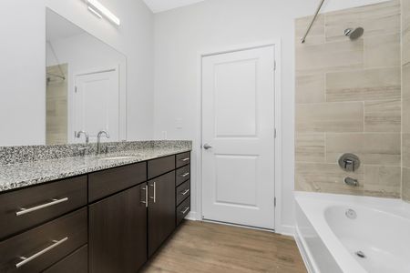 Apartments In Santa Rosa For Rent - The Southern - Bathroom Featuring Tub, Shower, Granite Countertop, And Large Mirror